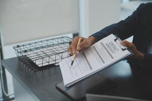 A man in a suit is filling out a job application photo