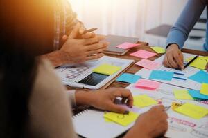 People sitting at a table with sticky notes photo