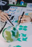 Two people are working on a project with a globe and other items photo