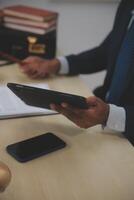 A man in a suit holding a tablet computer photo