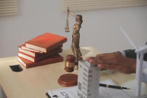 Lawyer at desk with books and statue of justice photo
