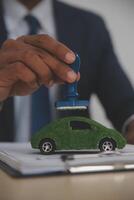 A man in a suit holding a toy car photo