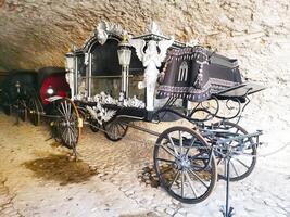 Luxurious royal carriage decorated with statues and decorative elements photo