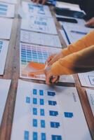 A person is looking at a table with various papers photo