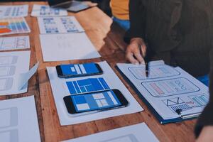 A person is working on a mobile app on a table photo