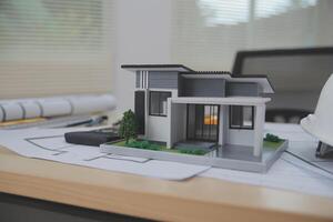 A model of a house sitting on top of a desk photo