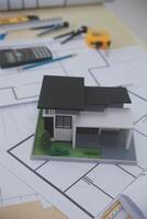 A model of a house is sitting on top of a desk photo