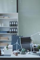 A white desk with a laptop photo