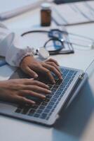 A person typing on a laptop computer photo