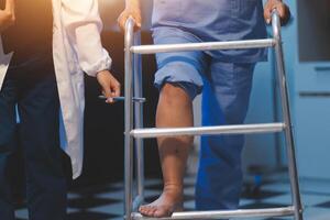 A doctor is standing on a ladder while a nurse is holding a leg photo