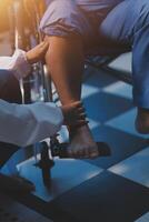 A doctor is helping a patient in a wheelchair photo