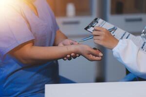 A doctor checking the arm of a patient photo