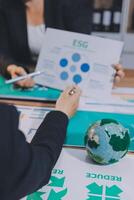 Business people working on a project with a globe and graphs photo