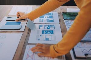 A person is working on a design project on a table photo