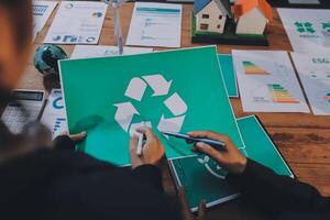 Recycling concept business people working on paper with recycling symbol photo