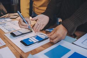 Two people working on a mobile app on a table photo