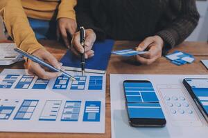 Two people working on a mobile app design photo