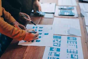 Two people working on a design document on a table photo