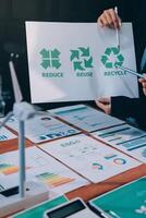 A man holding a paper with the words recycle and recycle on it photo