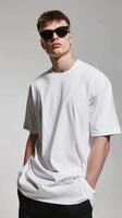A man in sunglasses and a white t - shirt photo