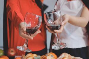 Two women holding wine glasses with fruit and vegetables photo