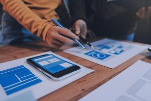A person is working on a mobile app on a table photo
