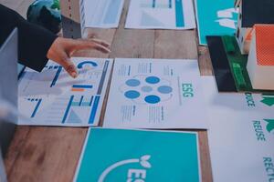 A person is looking at a table with papers and a house photo