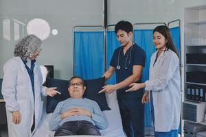 A group of doctors and nurses standing around a patient in a hospital bed photo