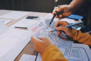 A person is working on a project with a pen and paper photo