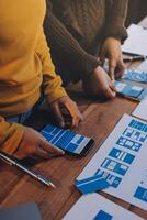 A group of people working on a project with blue and white icons photo