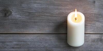 Burnout recovery mental concept. A lit candle on rustic wooden surface. photo