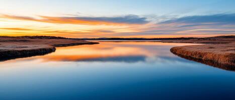 Burnout recovery mental concept. Tranquil river reflecting a colorful sunset over the horizon. photo