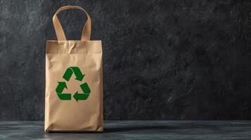 Recycle sustainability recovery concept. Eco-friendly paper bag with a green recycling symbol on a dark background. photo