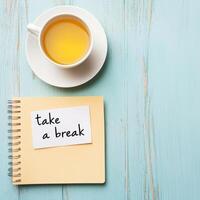 Burnout recovery stress concept. Cup of tea and notebook message on a wooden table. photo