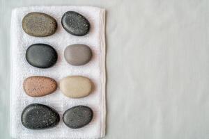 Burnout recovery stress concept. Smooth stones arranged on a cloth against a textured background. photo