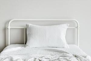 Burnout recovery mental concept. Minimalist bed with white bedding and a textured pillow against a neutral wall. photo