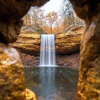 Landscape with Wealth concept. Waterfall framed by rocks in a serene autumn landscape. photo