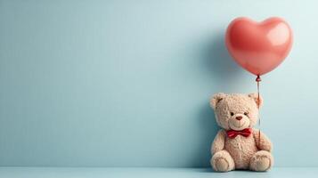 Teddy bear holding heart shaped balloon on blue background photo