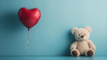 Teddy bear and heart shaped balloon on blue background photo