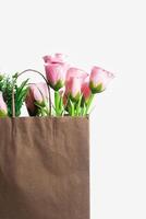 Beautiful pink roses decorated in a paper bag photo