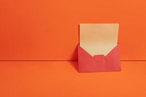 An open envelope on an orange background photo