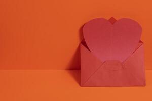 An open envelope with a red heart shape inside photo