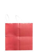 Red paper shopping bag with white handles on a white background photo