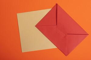 Red envelope and envelope on orange background photo