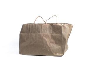 Brown paper bag with handles for shopping on white background photo