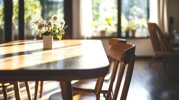 Bright and inviting dining area with wooden table, chairs, and floral centerpiece in a sunlit room photo