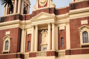 A large red brick building with a clock on the front photo