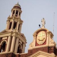 A building with a clock and a cross on it photo