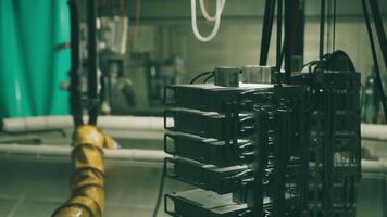 Overview of industrial machinery with metal components and cables in a workshop video
