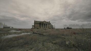 Old abandoned mansion stands alone in a desolate landscape under cloudy sky video